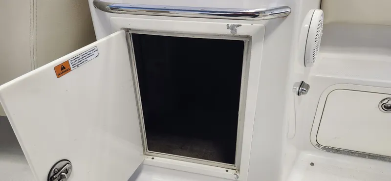 Slide: The Image of Open storage compartment on a 2004 Chris-Craft Corsair 25 boat. - 15