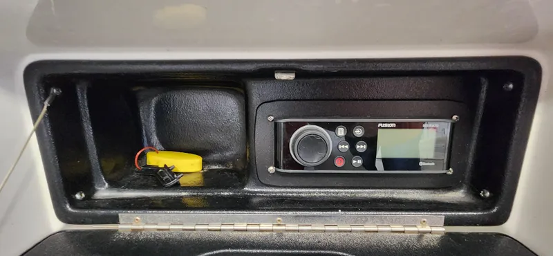 Slide: The Image of 2004 Chris-Craft Corsair 25 dashboard with a Fusion marine stereo system. - 17