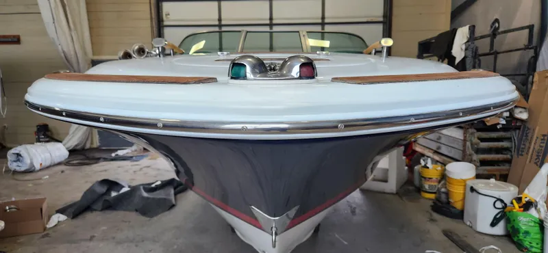 Slide: The Image of 2004 Chris-Craft Corsair 25 boat in a garage, front view. - 21