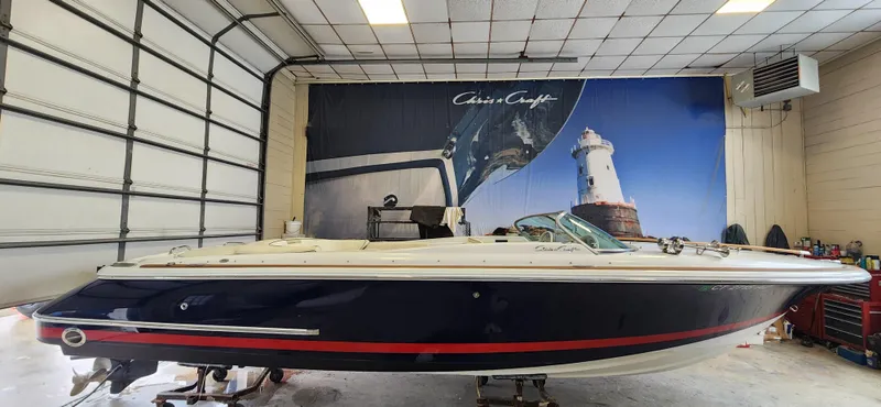 Slide: The Image of 2004 Chris-Craft Corsair 25 boat in a garage with a lighthouse mural. - 22