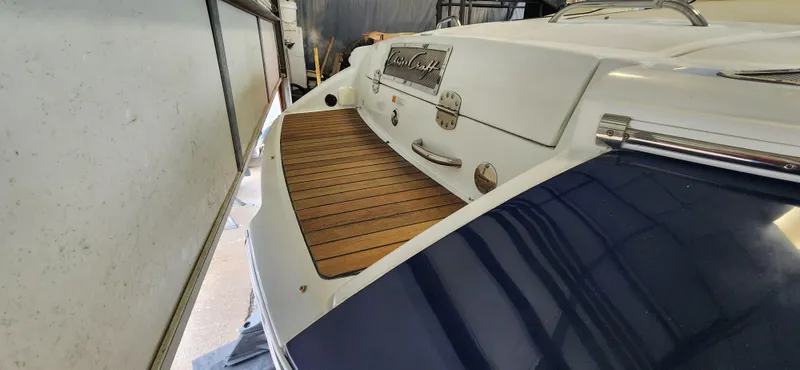 Slide: The Image of 2004 Chris-Craft Corsair 25 boat stern with teak swim platform in storage. - 25