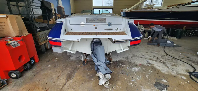 Slide: The Image of 2004 Chris-Craft Corsair 25 in a garage undergoing maintenance. - 28