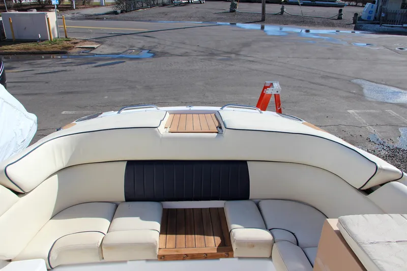 Slide: The Image of 2004 Chris-Craft Corsair 25 boat interior with white and navy seating. - 34