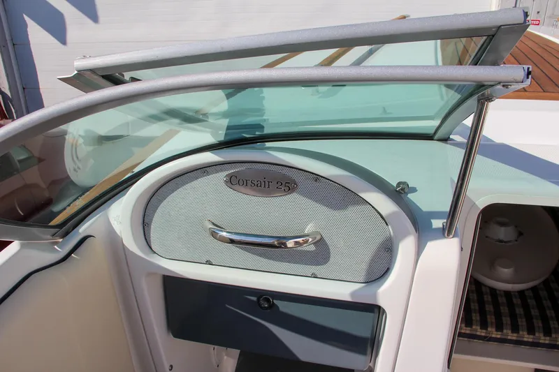 Slide: The Image of 2004 Chris-Craft Corsair 25 boat interior with open windshield and dashboard. - 37