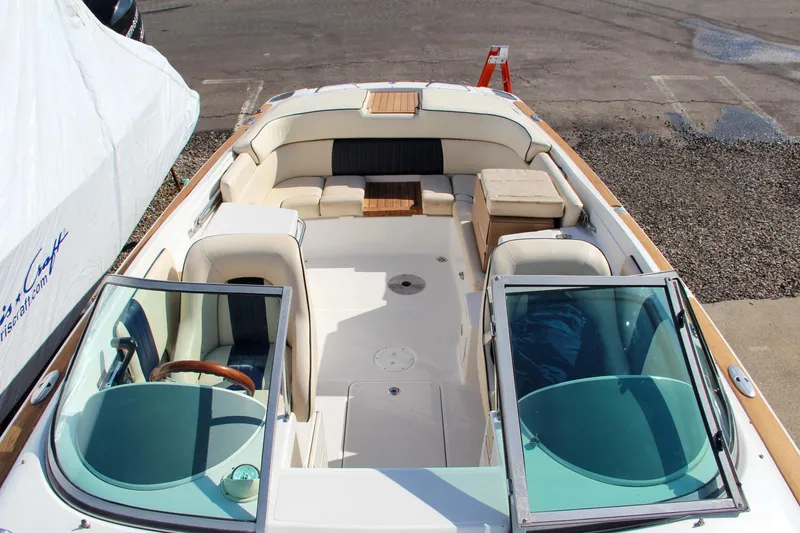Slide: The Image of 2004 Chris-Craft Corsair 25 boat interior with beige seating and wooden accents. - 40
