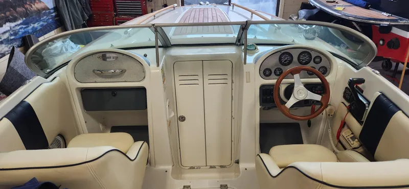 Slide: The Image of 2004 Chris-Craft Corsair 25 boat interior with steering wheel and dashboard. - 7