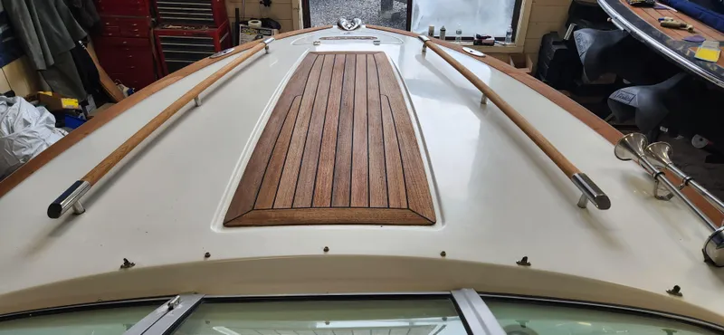 Slide: The Image of 2004 Chris-Craft Corsair 25 boat deck with wooden accents in a workshop. - 9