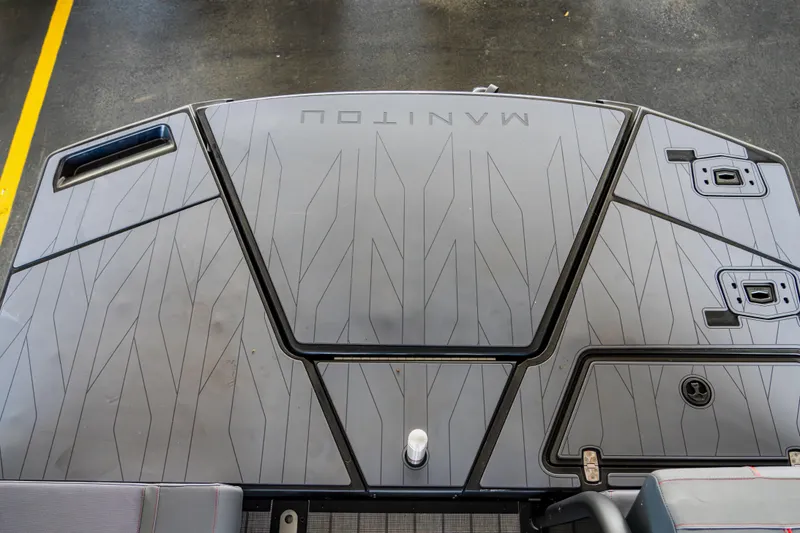 Slide: The Image of 2023 Manitou 22 Explore Bench boat deck with sleek design and storage compartments. - 2