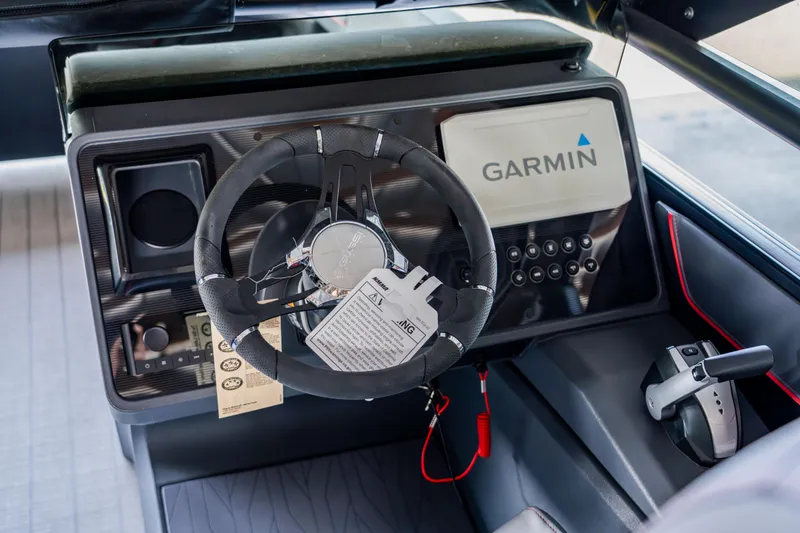 Slide: The Image of 2023 Manitou 22 Explore Bench boat dashboard with Garmin navigation system. - 3