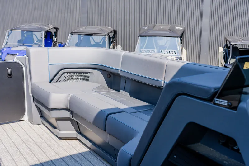 Slide: The Image of 2023 Manitou 24 EXPLORE SWITCHBACK boat interior with gray seating and modern design. - 6