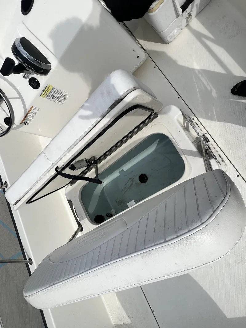 Slide: The Image of 2018 Boston Whaler 190 Montauk boat interior with open storage compartment. - 11