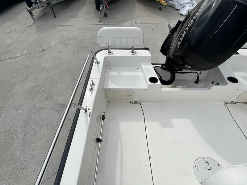 Slide: The Image of 2018 Boston Whaler 190 Montauk boat stern with Mercury outboard motor. - 12