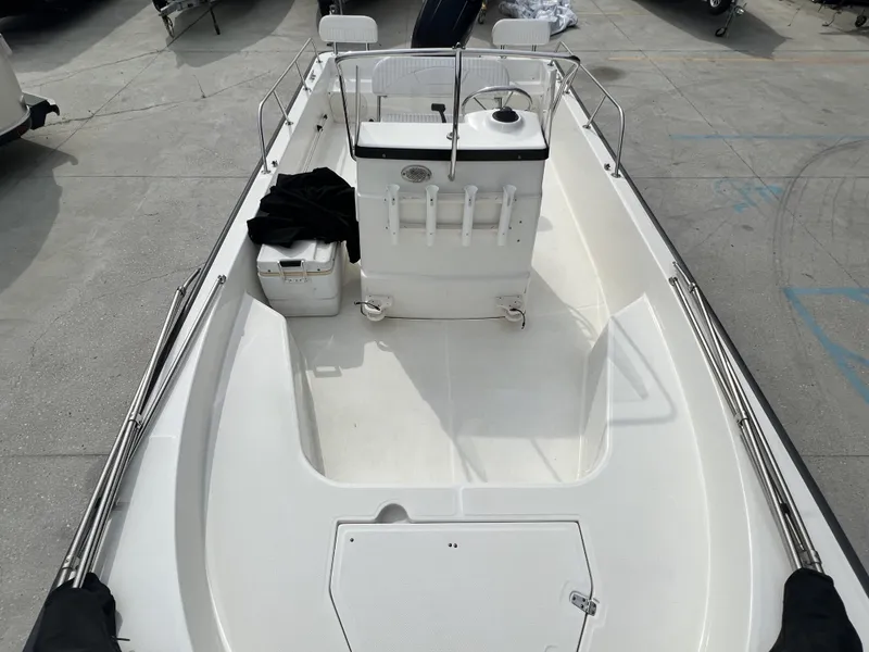 Slide: The Image of 2018 Boston Whaler 190 Montauk boat interior with center console and cooler. - 13
