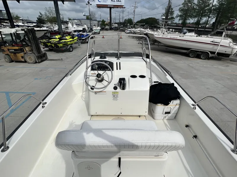 Slide: The Image of 2018 Boston Whaler 190 Montauk boat interior at a marina with other boats. - 14