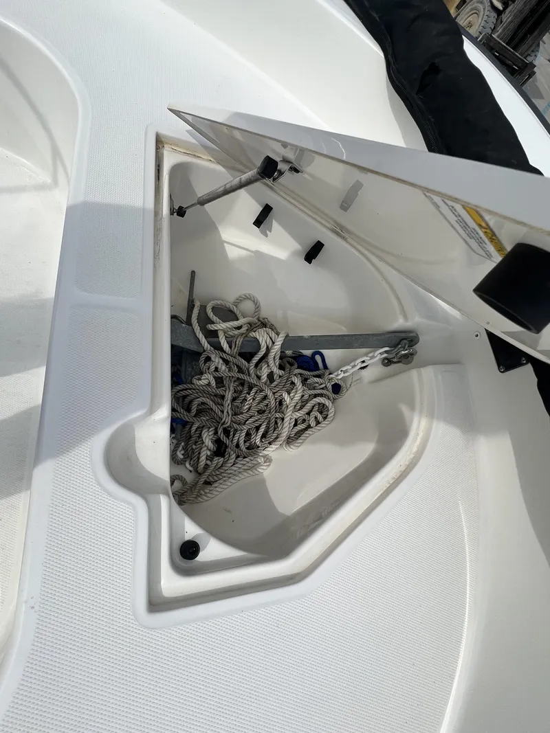 Slide: The Image of Open storage compartment on a 2018 Boston Whaler 190 Montauk boat with ropes inside. - 5