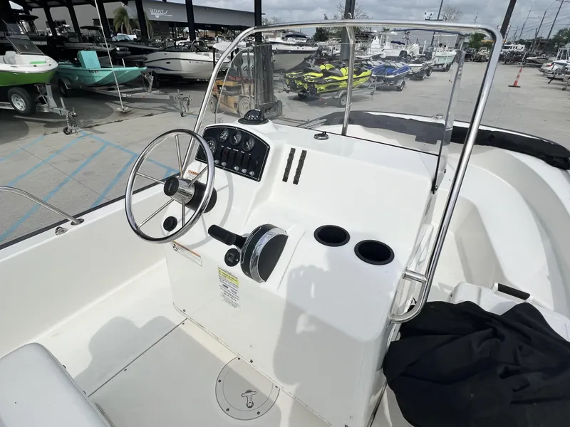Slide: The Image of 2018 Boston Whaler 190 Montauk boat interior with steering wheel and control panel. - 9