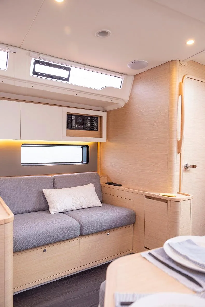 Slide: The Image of Modern interior of Dufour 44 yacht with cozy seating area. - 7