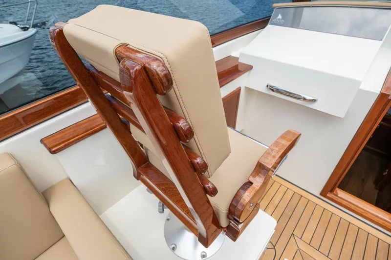 Slide: The Image of Vento V40 Retro Classic Open 2023 boat interior with wooden and beige leather seating. - 13