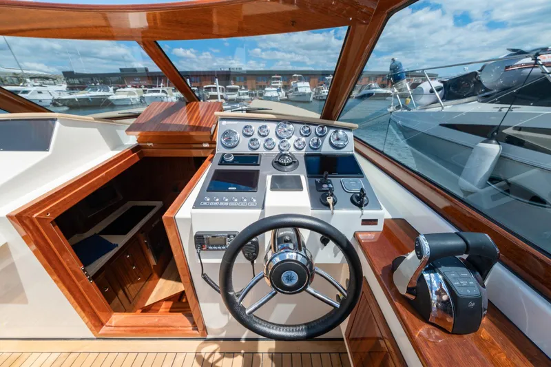 Slide: The Image of Vento V40 Retro Classic Open 2023 boat cockpit with wooden accents and modern controls. - 17