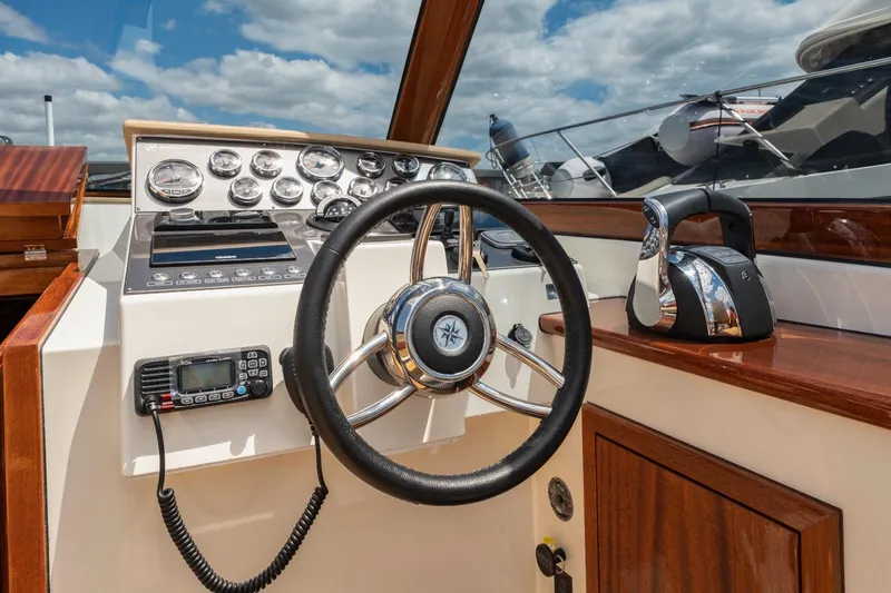 Slide: The Image of Vento V40 Retro Classic Open 2023 boat dashboard with steering wheel and control panel. - 18