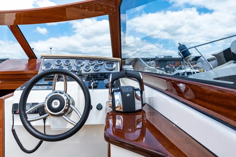 Slide: The Image of Vento V40 Retro Classic Open 2023 boat dashboard with steering wheel and controls. - 19