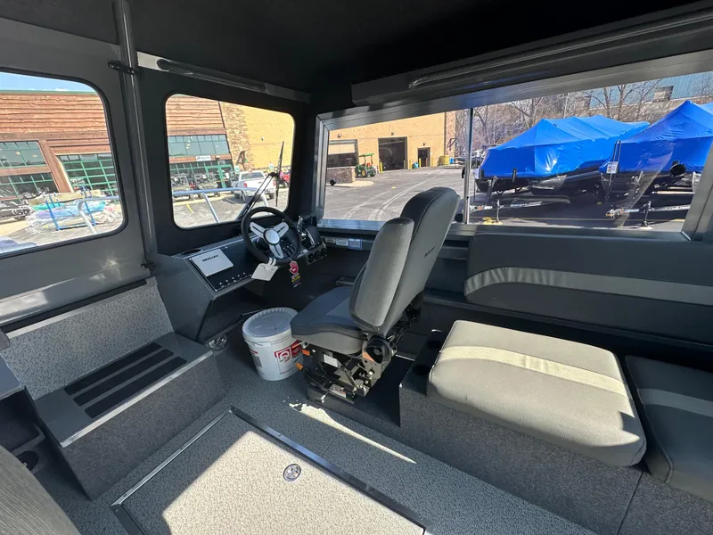 Slide: The Image of Interior of 2024 Spartan 260 Maximus Pro XL boat with seating and steering console. - 10