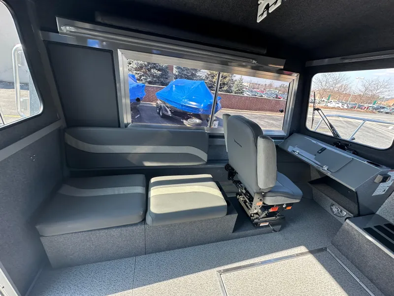 Slide: The Image of Interior of 2024 Spartan 260 Maximus Pro XL boat with seating and windows. - 11