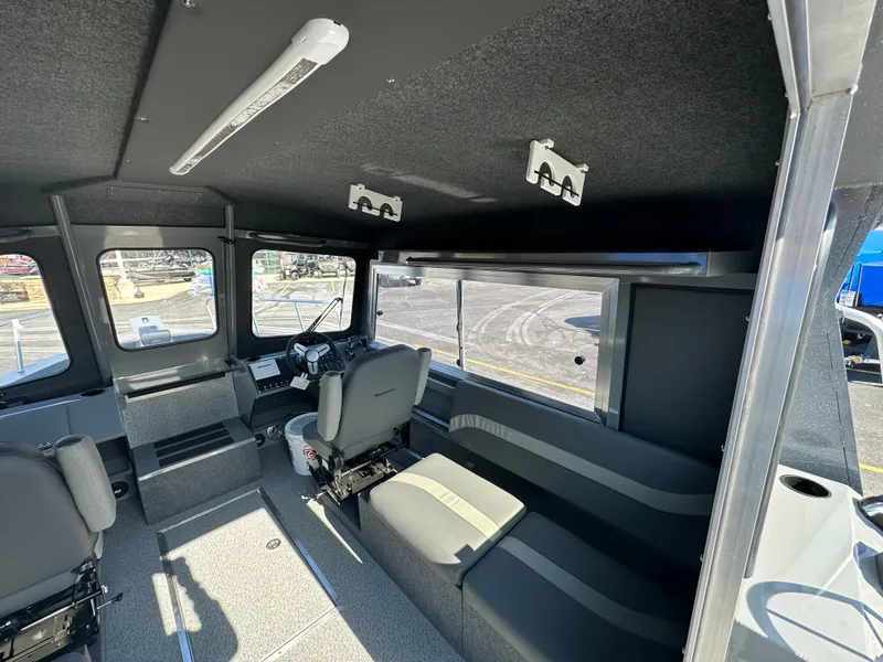 Slide: The Image of Interior of 2024 Spartan 260 Maximus Pro XL boat with seating and control console. - 12