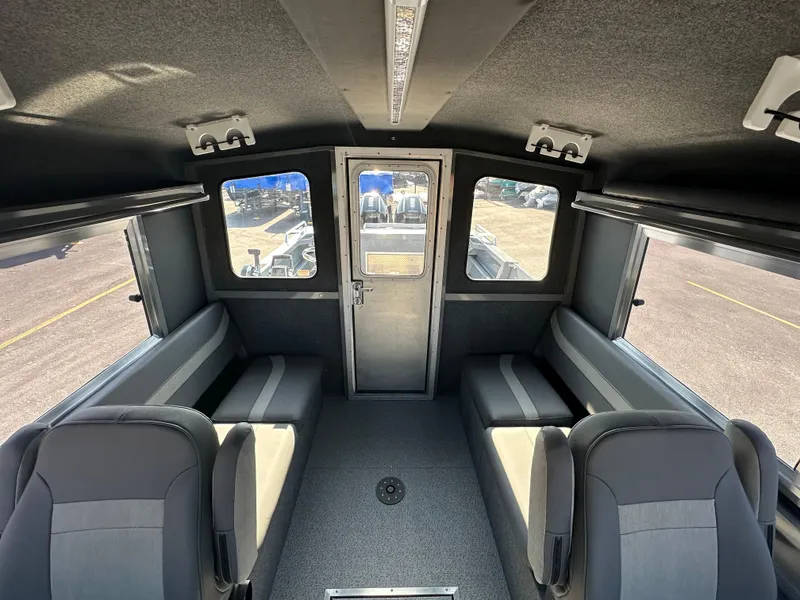 Slide: The Image of Interior of 2024 Spartan 260 Maximus Pro XL boat with seating and windows. - 14