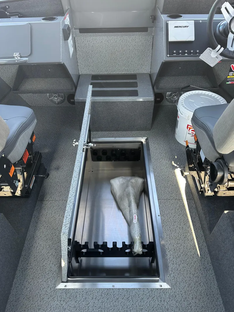 Slide: The Image of 2024 Spartan 260 Maximus Pro XL boat interior with open storage compartment. - 15