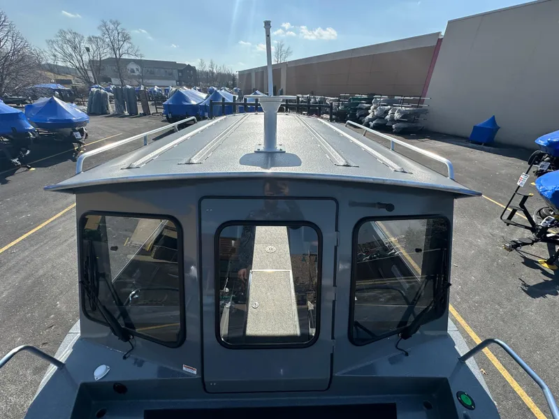 Slide: The Image of 2024 Spartan 260 Maximus Pro XL boat in a parking lot. - 17