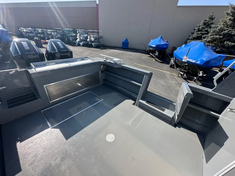 Slide: The Image of 2024 Spartan 260 Maximus Pro XL boat deck in a parking lot. - 19