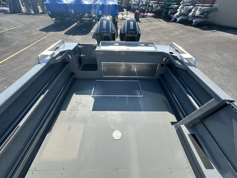 Slide: The Image of 2024 Spartan 260 Maximus Pro XL boat interior with dual outboard motors. - 20