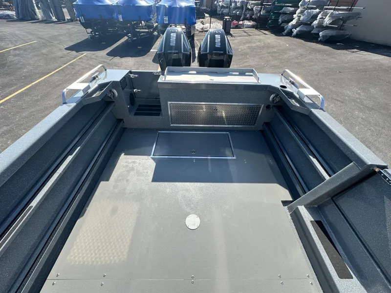 Slide: The Image of 2024 Spartan 260 Maximus Pro XL boat interior with dual outboard motors. - 21