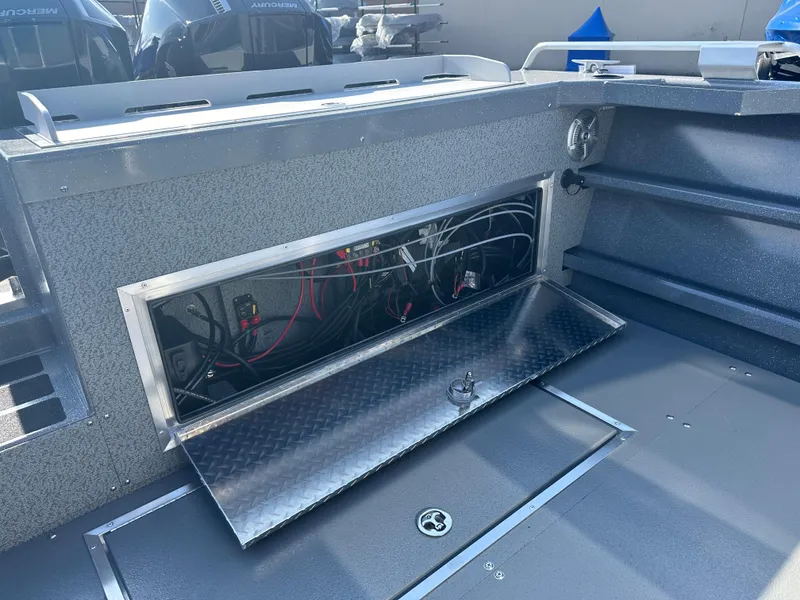 Slide: The Image of 2024 Spartan 260 Maximus Pro XL boat interior wiring compartment. - 25