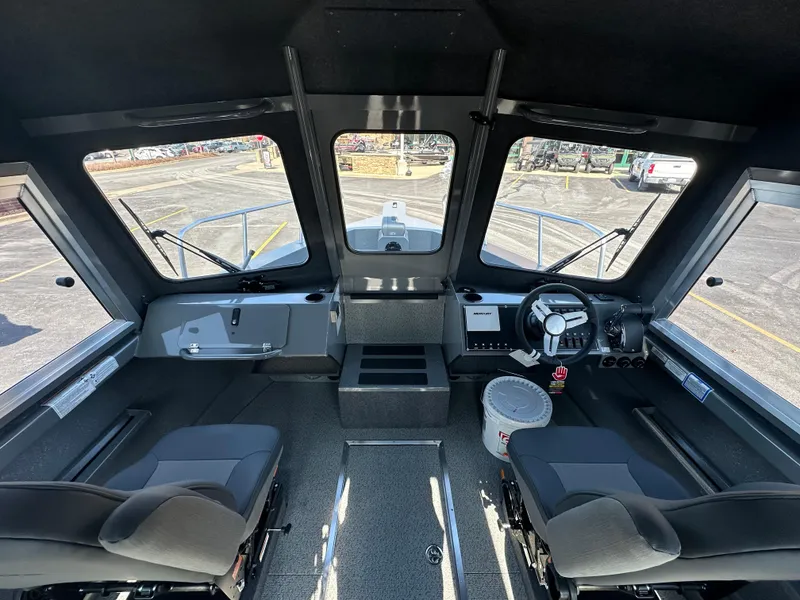 Slide: The Image of 2024 Spartan 260 Maximus Pro XL boat interior with dual seats and modern dashboard. - 6