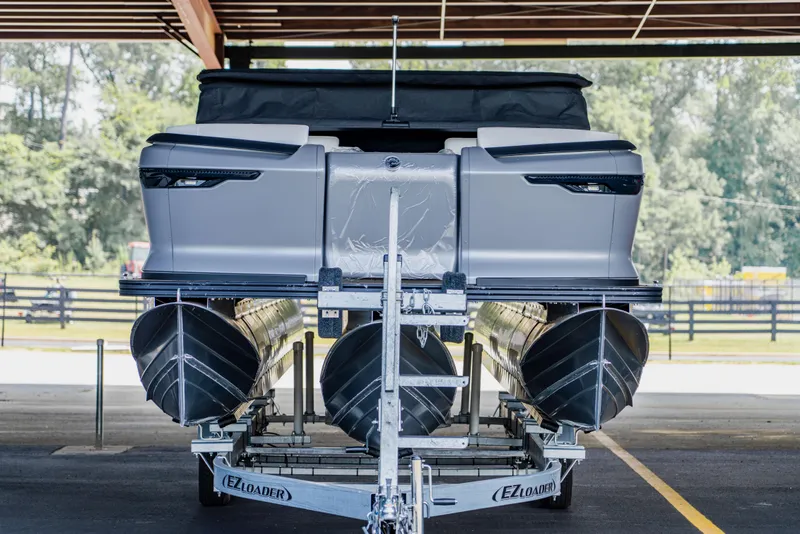 Slide: The Image of 2024 Manitou 26 Explore SHP575 Switchback pontoon boat on EZ Loader trailer. - 2