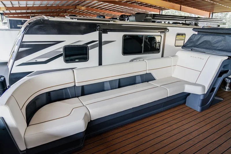 Slide: The Image of 2024 Manitou 26 Explore SHP575 Switchback boat with spacious seating and modern design. - 4