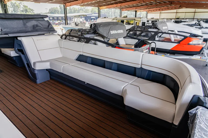 Slide: The Image of 2024 Manitou 26 Explore SHP575 Switchback boat interior with spacious seating. - 5