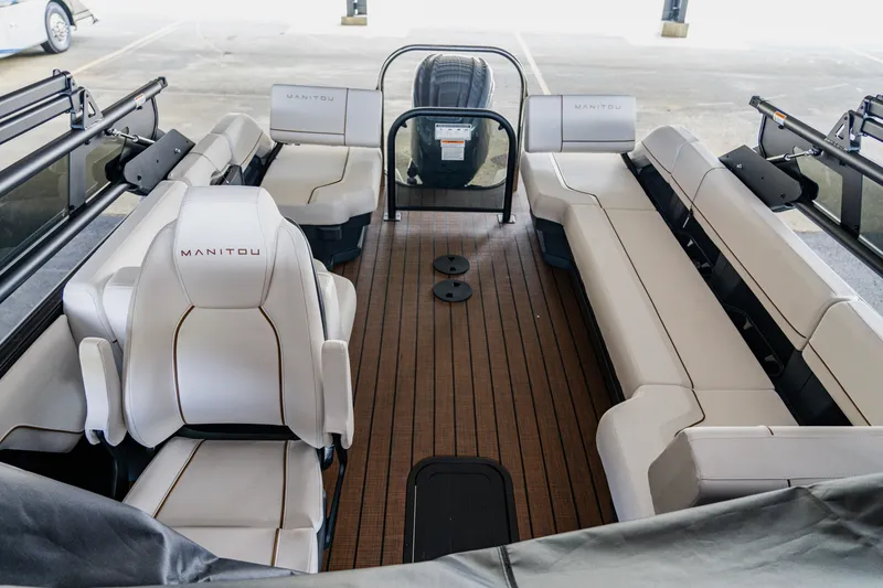 Slide: The Image of 2024 Manitou 26 Explore SHP575 Switchback pontoon boat interior with spacious seating. - 6