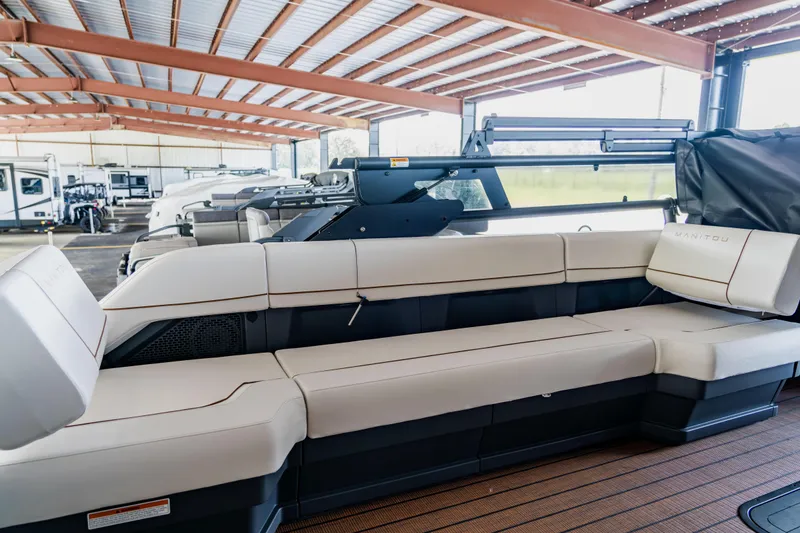 Slide: The Image of 2024 Manitou 26 Explore SHP575 Switchback pontoon boat interior under covered storage. - 8