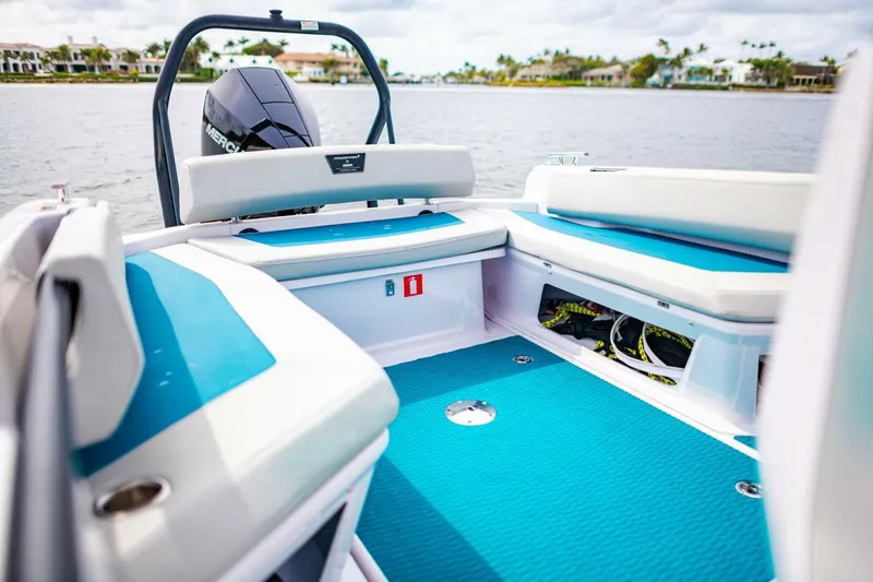 Slide: The Image of 2022 Axopar 22 Spyder x Jobe Revolve boat interior with blue and white seating. - 10
