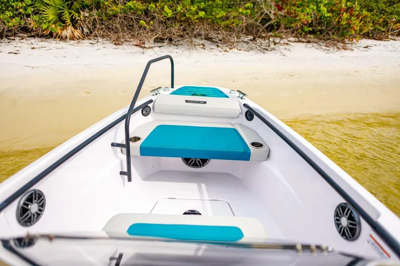 Slide: The Image of Axopar 22 Spyder x Jobe Revolve 2022 boat interior with turquoise seating near sandy beach. - 17