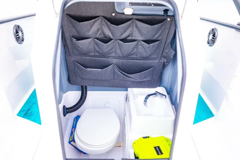 Slide: The Image of 2022 Axopar 22 Spyder x Jobe Revolve boat interior with toilet and storage. - 19