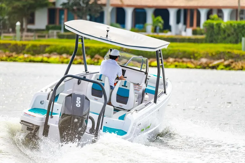 Slide: The Image of 2022 Axopar 22 Spyder x Jobe Revolve boat cruising on water. - 7