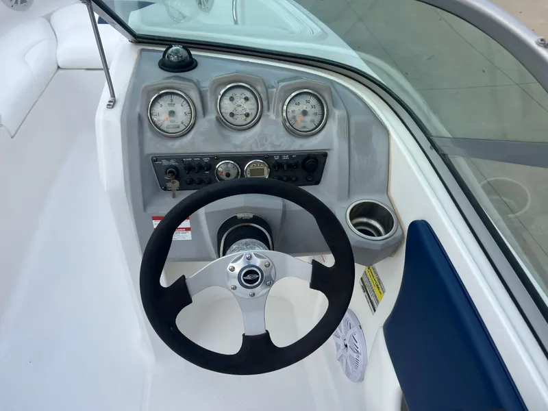 Slide: The Image of Steering console of a 2013 Chaparral 19 Sport H2O boat with gauges and controls. - 11