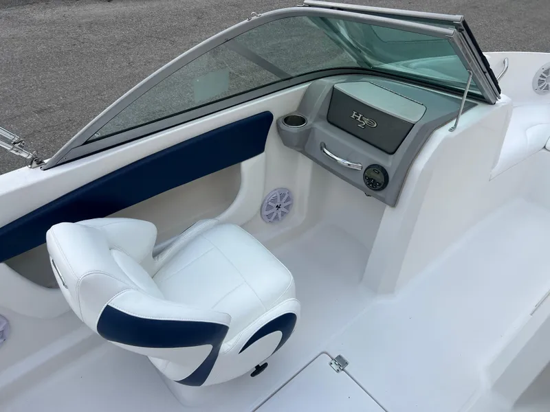 Slide: The Image of 2013 Chaparral 19 Sport H2O boat interior with white and blue seating. - 13