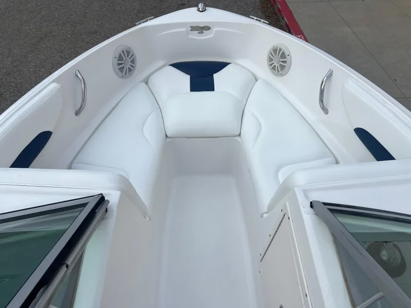 Slide: The Image of 2013 Chaparral 19 Sport H2O boat interior with white and blue seating. - 14