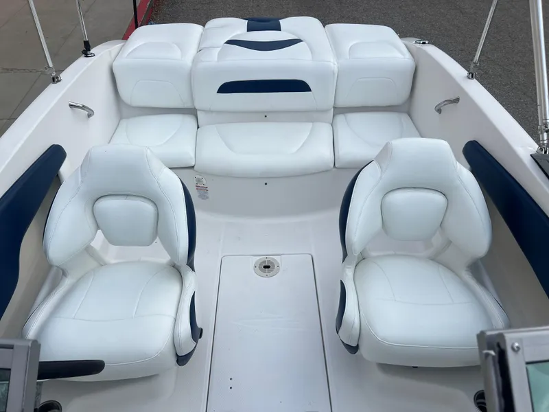 Slide: The Image of 2013 Chaparral 19 Sport H2O boat interior with white and blue seating. - 15