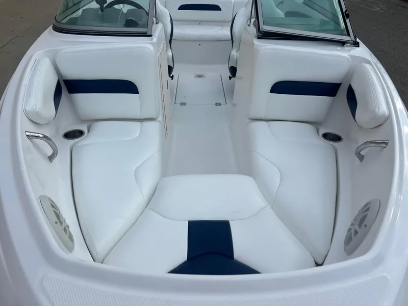 Slide: The Image of 2013 Chaparral 19 Sport H2O boat interior with white and blue seating. - 3